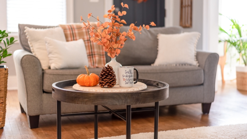A cozy living room with warm colors, soft textures, and balanced decor